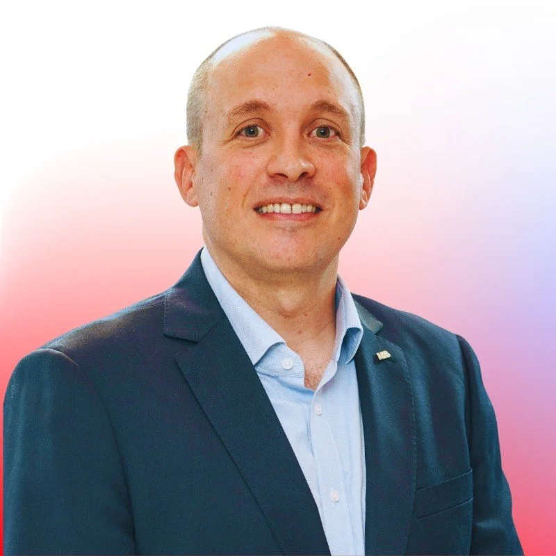 Smiling man in a suit against a gradient background