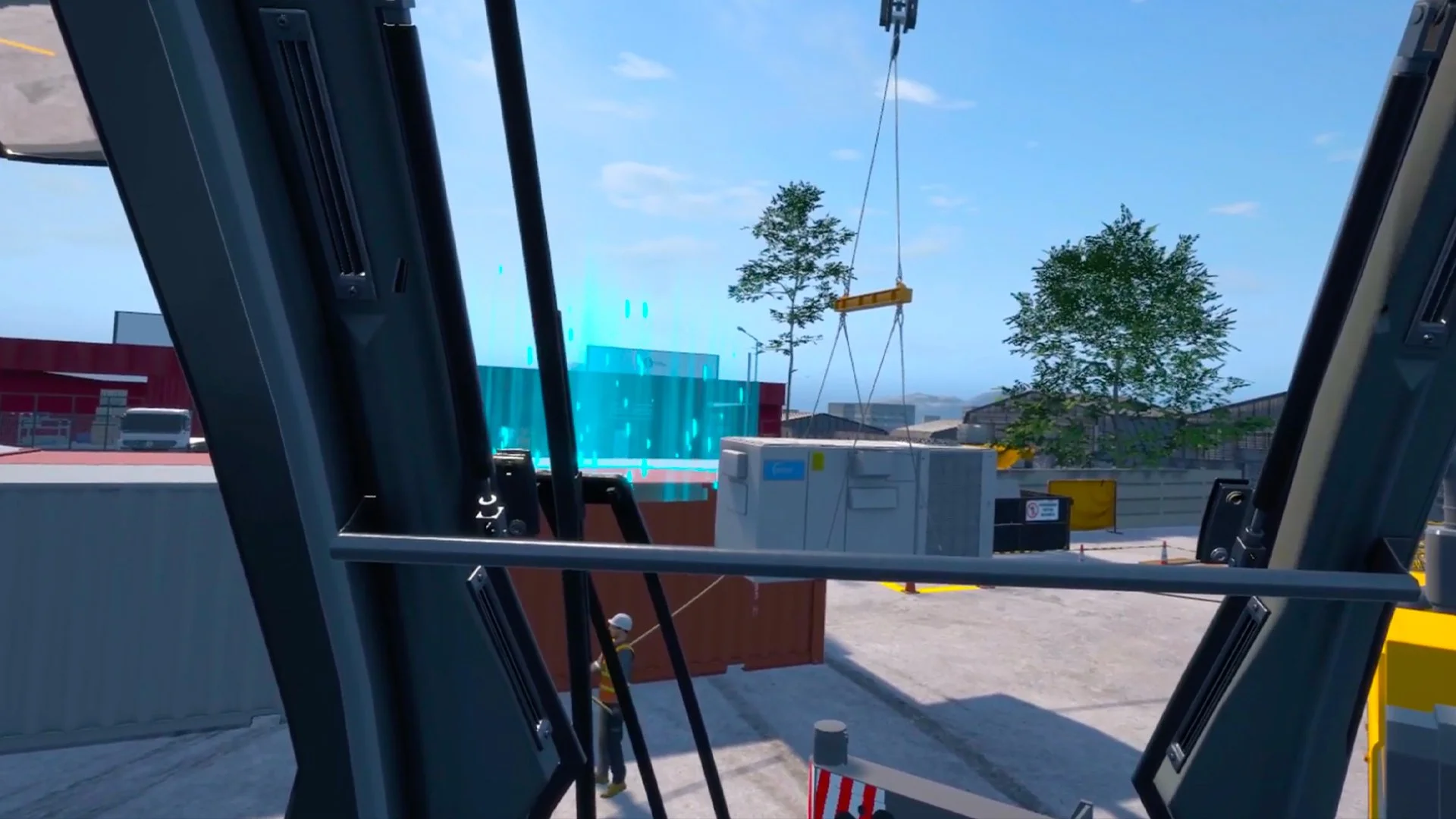 View of a construction site from inside a vehicle, showing a crane lifting a container and a worker below. Containers and trees are in the background.