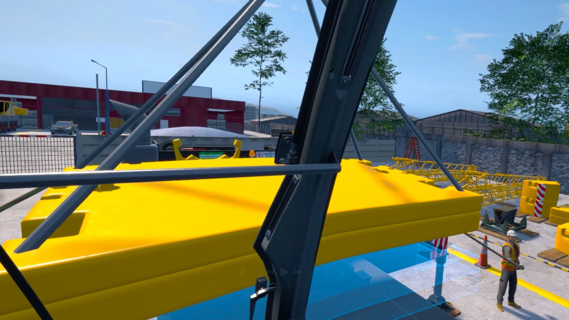 Construction site with yellow crane components, a worker in safety gear, and several buildings in the background.