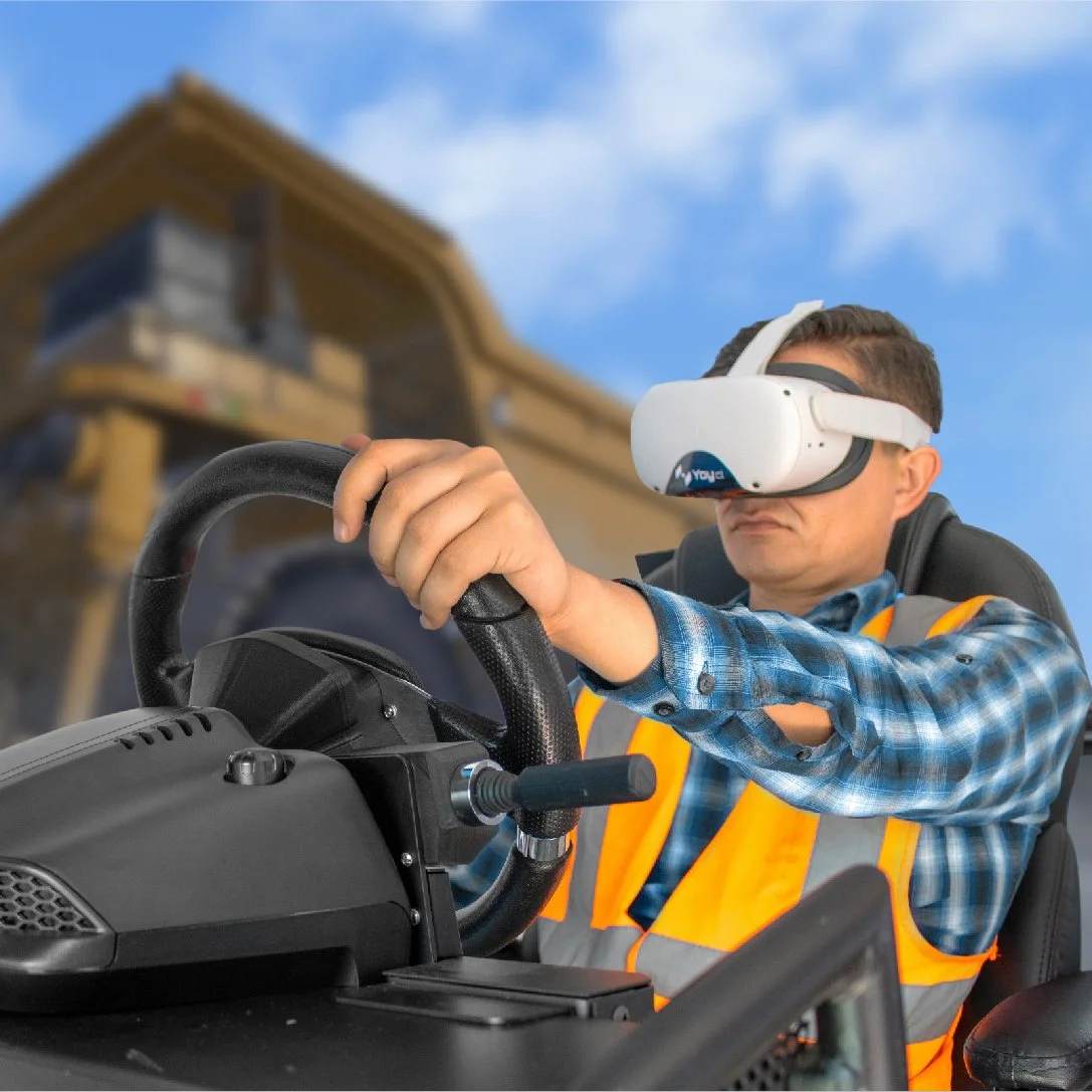 Person wearing a VR headset operating a vehicle simulator